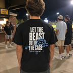 Teen wearing a black Beast adult baseball T-shirt with large back graphic at the ballpark.