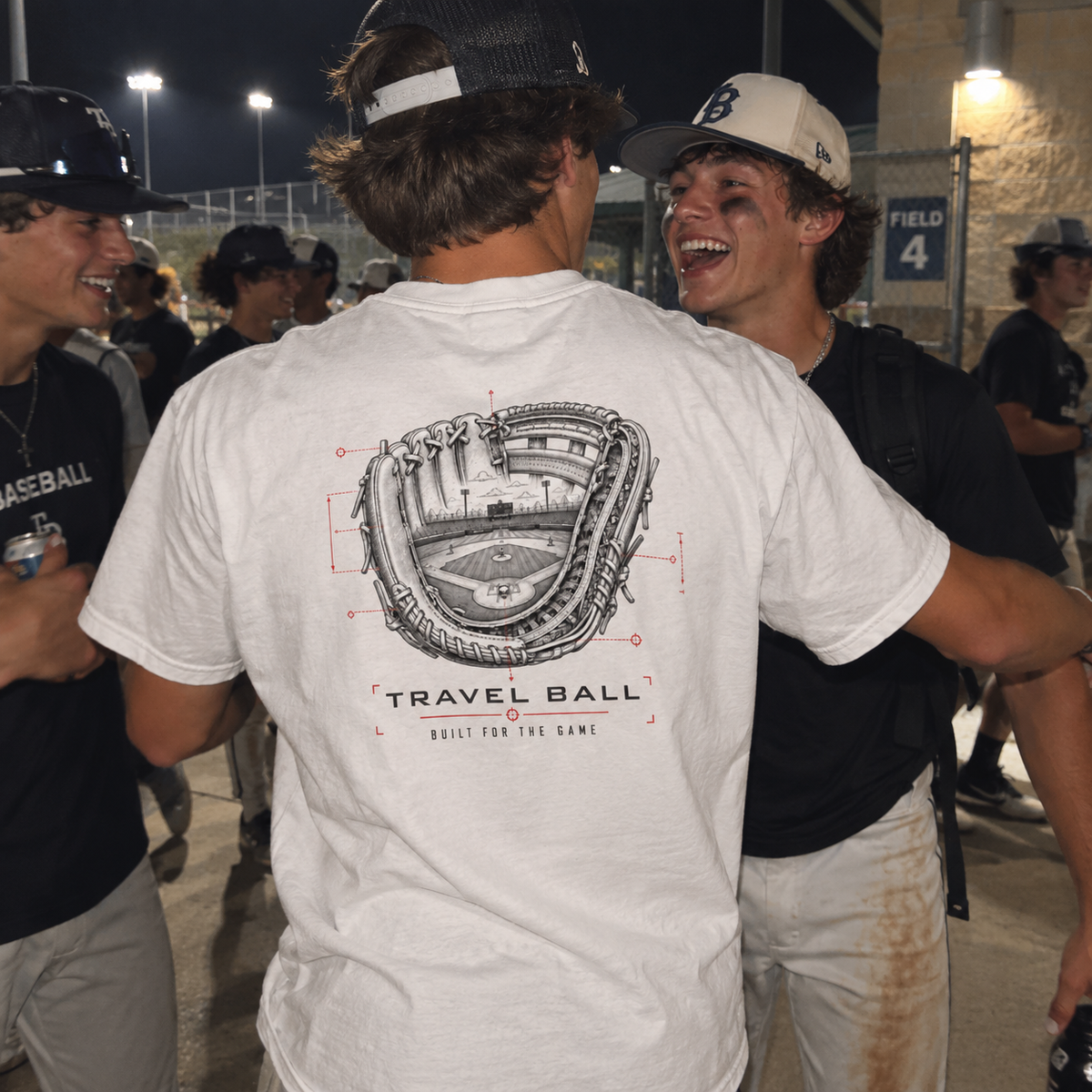 Teen baseball player wearing a white Built for the Game Glove adult T-shirt with the Travel Ball glove-and-ballpark back graphic.
