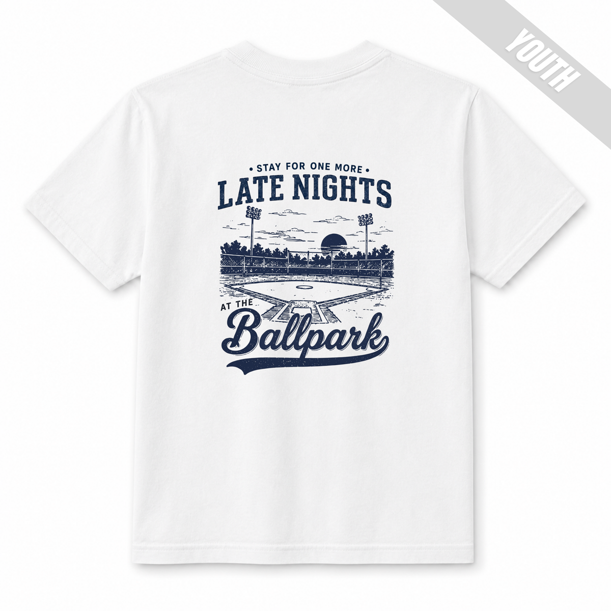 White youth baseball T-shirt with large “Late Nights at the Ballpark” back graphic.