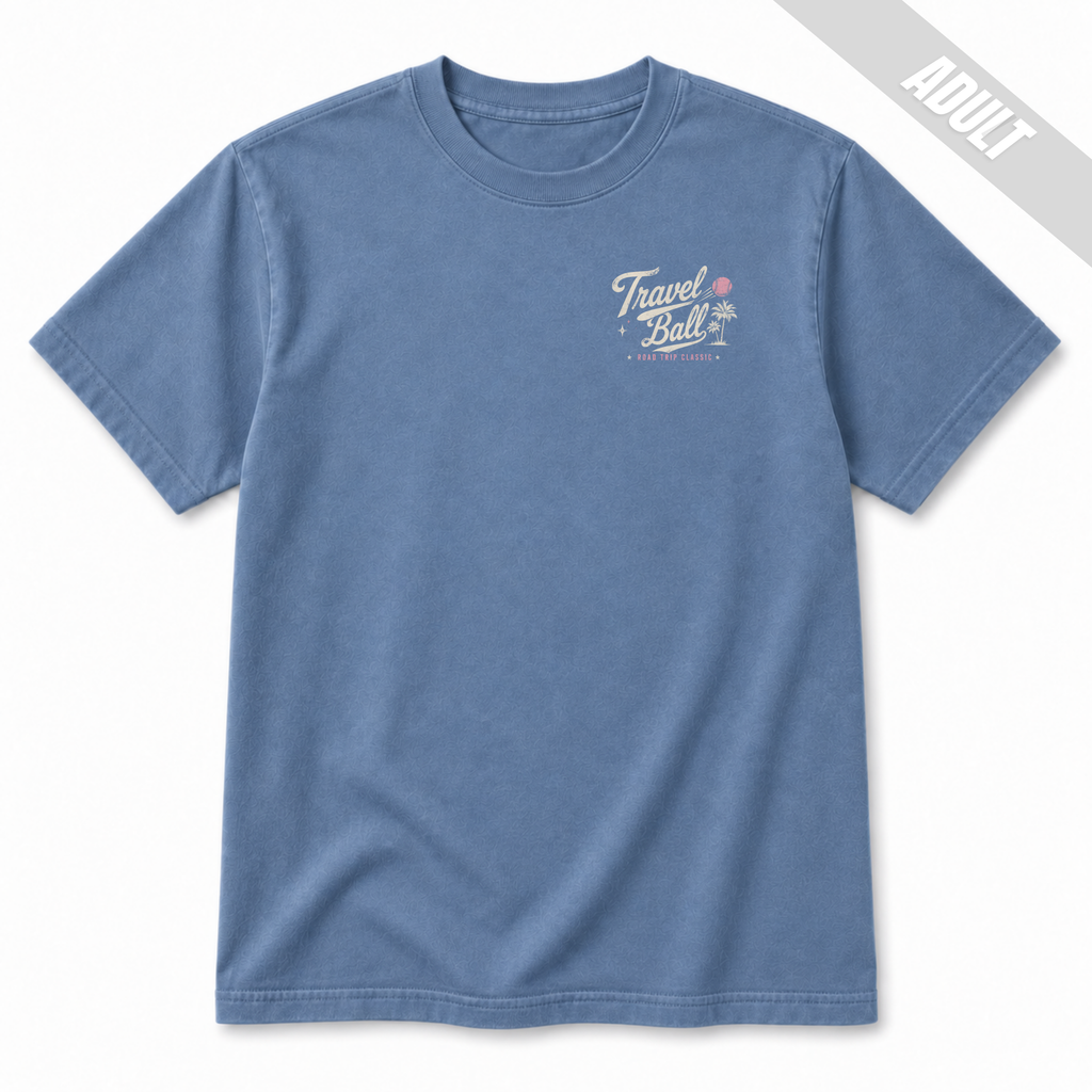 Front view of an adult Washed Denim travel ball T-shirt featuring a small left chest Travel Ball Road Trip Classic graphic in off-white and pink.
