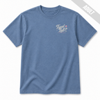 Front view of an adult Washed Denim travel ball T-shirt featuring a small left chest Travel Ball Road Trip Classic graphic in off-white and pink.