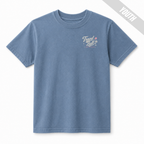 Front view of a Washed Denim youth travel ball T-shirt with a small off-white and pink Travel Ball Road Trip Classic graphic on the left chest.